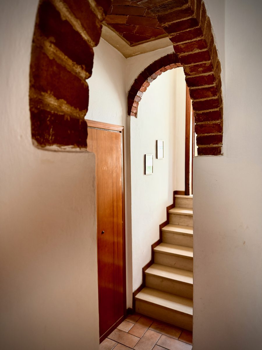 il Nido staircase with striking brick archway