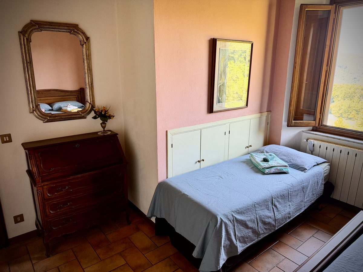 il Nido bedroom with antique dresser and mirror